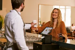 Gast bezahlt in einer Gastronomie ihren Kaffee am Kassensystem orderbird PRO